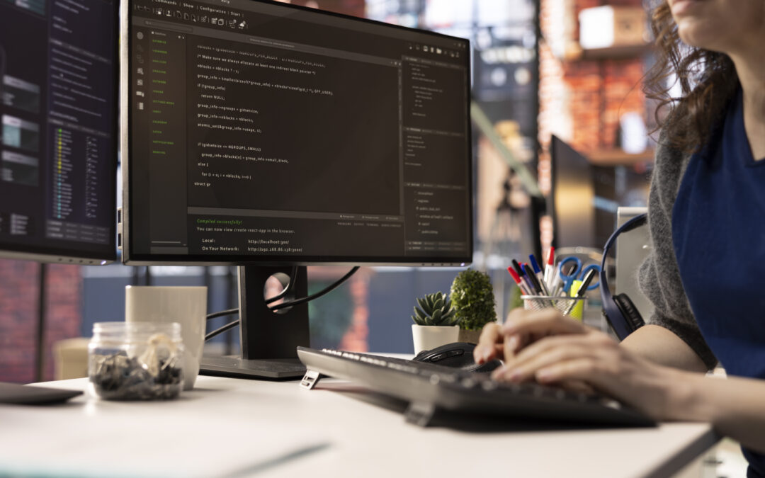 Website developer at the office looking at UI on computer monitor and executing programming code. IT freelance worker using coding application to write and test code in modern apartment.